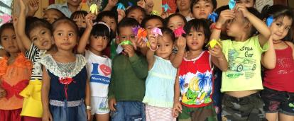 Projects Abroad volunteers pose with children on the Cambodia Childcare Project